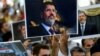 People hold pictures of the late former Egyptian President Mohamed Morsi during a symbolic funeral ceremony, June 18, 2019 at Fatih mosque in Istanbul, Turkey.