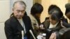 A Public Relations staff of JGC Corp answers reporters' questions regarding Japanese nationals who were kidnapped in Algeria, at its headquarters in Yokohama, south of Tokyo in this photo taken by Kyodo, January 16, 2013.
