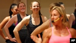Women participate in a fitness class lead by Kira Stokes, right, at NYSC Lab in New York, May 11, 2017.