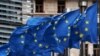 European Union flags fly outside the European Commission headquarters in Brussels, Belgium, March 6, 2019.