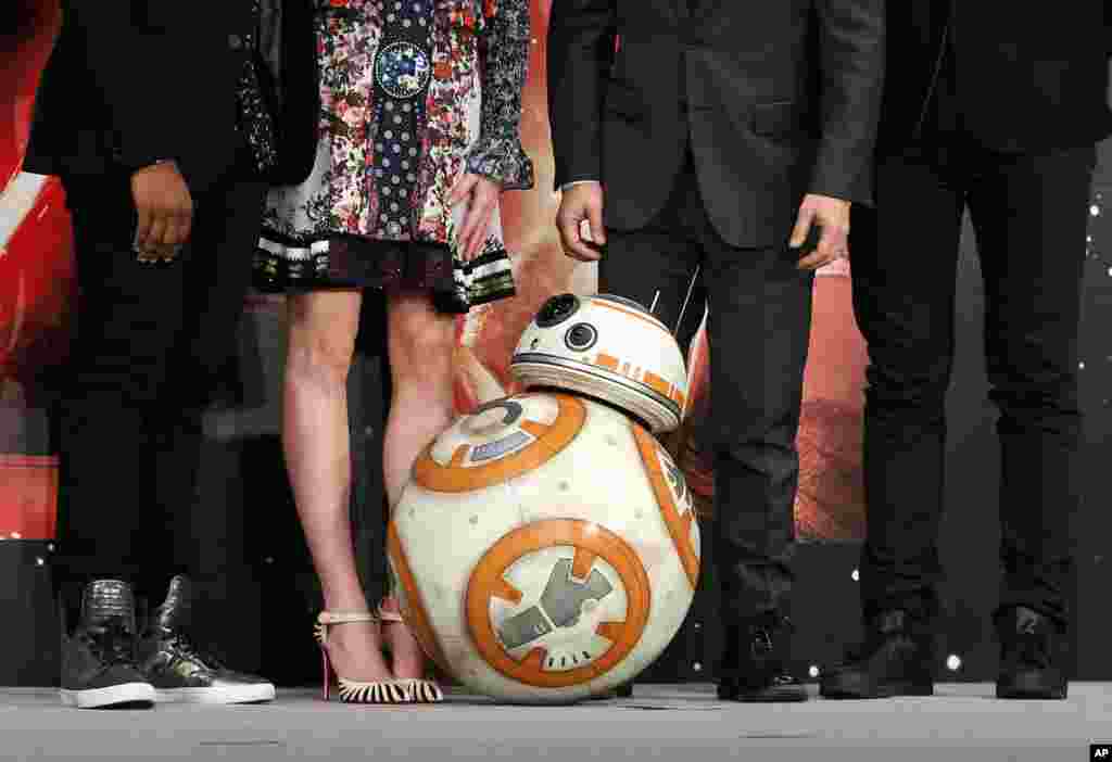 BB-8 droid poses with actors and the director during a press conference for their latest film "Star Wars: The Force Awakens" at a hotel in Urayasu, near Tokyo.