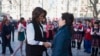 U.S. first lady Michelle Obama (L) is greeted by Peng Liyuan, wife of Chinese President Xi Jinping, upon arrival for a visit to the Beijing Normal School, a school which prepares students for university abroad, in Beijing, March 21, 2014.