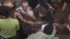 In this image taken from video, people carry a child's body pulled out from rubble following Saudi-led coalition airstrikes that killed dozens, including children, in the residential center of the capital, Sanaa, Yemen, May 16, 2019.