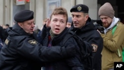 La police biélorusse arrête le journaliste Raman Pratasevich, au centre, à Minsk, en Biélorussie. 