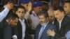 Egypt's President-elect Mohammed Morsi is guarded by presidential security as he leaves Friday prayers at Al-Azhar mosque, in Cairo, Egypt, Friday, June 29, 2012.