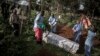FILE - Health workers prepare to bury a coffin containing a victim of the ebola virus on May 16, 2019 in Butembo, DRC.