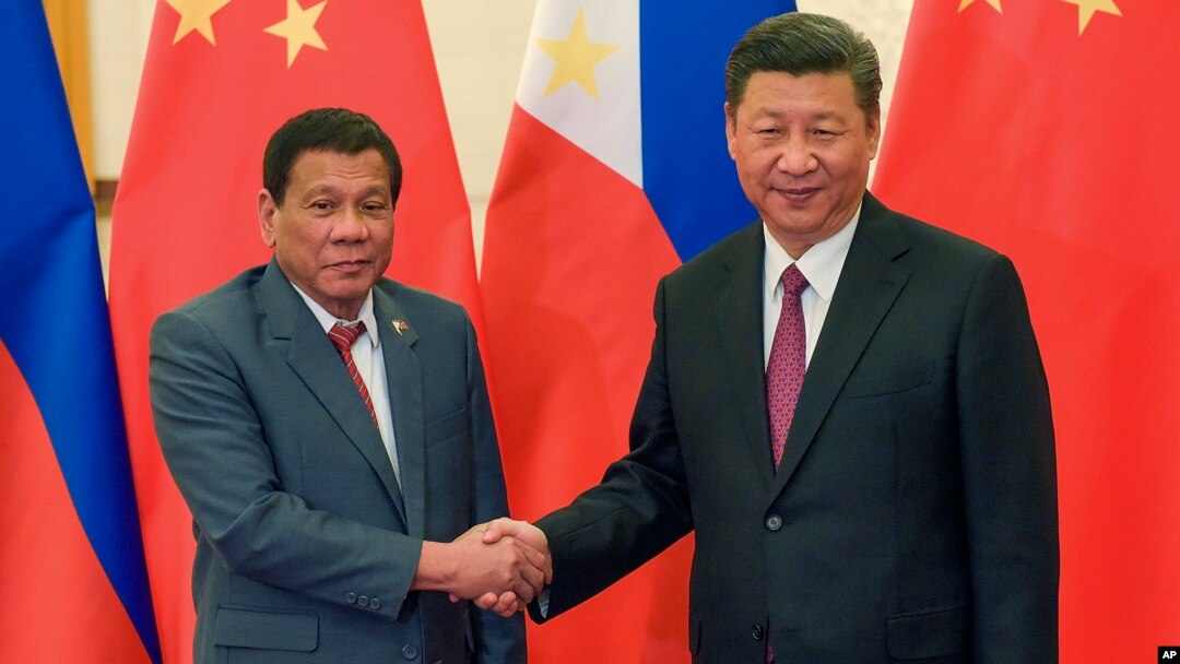 FILE - Philippine President Rodrigo Duterte, left, and Chinese President Xi Jinping pose for photographers on the sidelines of the Belt and Road Forum for International Cooperation at the Great Hall of the People in Beijing, May 15, 2017. 