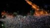 People flash the lights of their mobile phones during an anti-government protest in Victoria Square, outside the government headquarters in Bucharest, Romania, Aug. 10, 2019. 