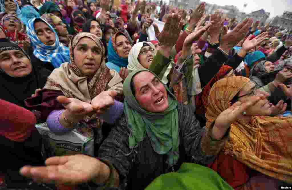 Kashmiri Muslims women react upon seeing a relic believed to be hair from the beard of Prophet Mohammed, on display on the Friday following the festival of Eid-e-Milad-ul-Nabi at Hazratbal shrine in Srinagar, India.