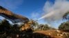 Turkish-backed rebel fighters fire a howitzer toward Syrian government forces' positions near the village of Neirab in Idlib province, Syria, Feb. 20, 2020. 