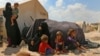FILE - Displaced Syrians are seen at a camp in Kafr Lusin near the Bab al-Hawa border crossing with Turkey in the northern part of Syria's rebel-held Idlib province, Sept. 6, 2018.