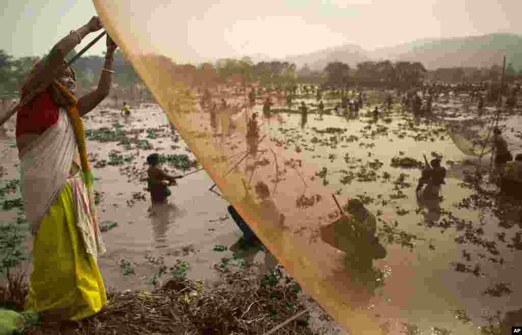 An villager prepares a fishing net during community fishing as part of the Bhogali Bihu celebrations at the Goroimari Lake in Panbari village, some 50 kilometers (31 miles) east of Gauhati, India.
