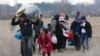 Migrants walk near Pazarkule at the Turkish-Greek border, March 5, 2020. 