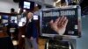 A trader passes a hand sanitizing station on the floor of the New York Stock Exchange, March 3, 2020. Federal Reserve Chairman Jerome Powell noted that the coronavirus "poses evolving risks to economic activity." 