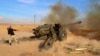 FILE - Syrian government troops fire at Islamic State group positions near Mahin, Syria, Jan. 30, 2016.