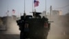 A convoy of U.S. forces armored vehicles drives near the village of Yalanli, on the western outskirts of the northern Syrian city of Manbij, March 5, 2017.