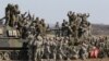South Korean and U.S. army, gray, soldiers cheer after a live fire drill during the annual Foal Eagle maneuvers near Rodriguez Range in Pocheon, south of the demilitarized zone that divides the two Koreas, South Korea, March 15, 2012.