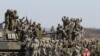 South Korean and U.S. army, gray, soldiers cheer after a live fire drill during the annual Foal Eagle maneuvers near Rodriguez Range in Pocheon, south of the demilitarized zone that divides the two Koreas, South Korea, March 15, 2012.