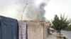 FILE - Smoke rises from the city of Lashkar Gah after airstrikes against Taliban in Helmand province southern of Kabul, Afghanistan, Aug. 6, 2021.