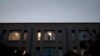 FILE - An employee inside Pakistan's embassy in Washington looks out a window, Nov. 5, 2007.