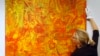 FILE - Christie's employee Rhiannon Broomfield poses for photographs beside the untitled painting by Aboriginal artist Emily Kame Kngwarreye which features in the forthcoming Modern and Contemporary Australian Art auction at the auction house's offices in London, Friday, Dec. 7, 2007. 