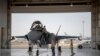 FILE - In this Aug. 5, 2019, photo released by the U.S. Air Force, an F-35 fighter jet pilot and crew prepare for a mission at Al-Dhafra Air Base in the United Arab Emirates.