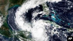 This Tuesday, Oct. 6, 2020, satellite image released by NASA Worldview, Earth Observing System Data and Information System (EOSDIS) shows a strengthening Hurricane Delta. Delta rapidly intensified into a dangerous Category 4 storm Tuesday while following…