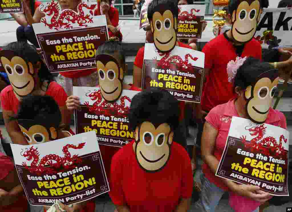 Protesters wear monkey masks during a rally at the Chinese Consulate in the financial district of Makati city, east of Manila, to protest China&#39;s &quot;continued incursions&quot; in the disputed islands off South China Sea. This year is the Year of Monkey in the Chinese lunar calendar.