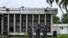 FILE - Police officers wearing face masks stands outside the Pasteur Institute of Ivory Coast, near Abidjan, May 11, 2020.