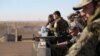 FILE - A Syrian Democratic Forces fighter looks through the scope of his weapon in Tal Samin village, north of Raqqa, Syria, Nov. 19, 2016.