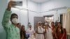 Health workers celebrate India administering 1 billion doses of COVID-19 vaccine, at Rajawadi hospital in Mumbai, India, Oct. 21, 2021.