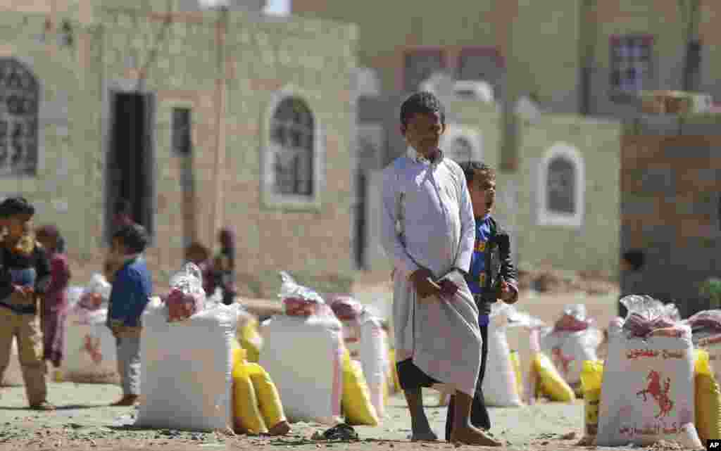 A displaced boy, who fled Saada province, northwest of Sana&#39;a with his family, waits for relief supplies during a food distribution by volunteers in Sana&#39;a, Yemen.