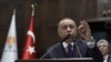 Turkey's President Recep Tayyip Erdogan addresses the members of his ruling party at the parliament, in Ankara, Turkey, Feb. 5, 2020. 
