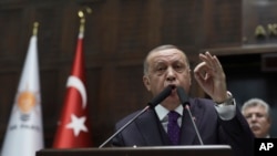 Turkey's President Recep Tayyip Erdogan addresses the members of his ruling party at the parliament, in Ankara, Turkey, Feb. 5, 2020. 