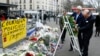 U.S. Secretary of State John Kerry (L) lays a wreath with French Foreign Minister Laurent Fabius at the site of an attack at a Jewish supermarket in Paris, January 16, 2015.