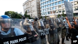 FILE - Police clear the area around Lafayette Park and the White House as demonstrators gather to protest the death of George Floyd, June 1, 2020, in Washington. Floyd died after being restrained by Minneapolis police officers.