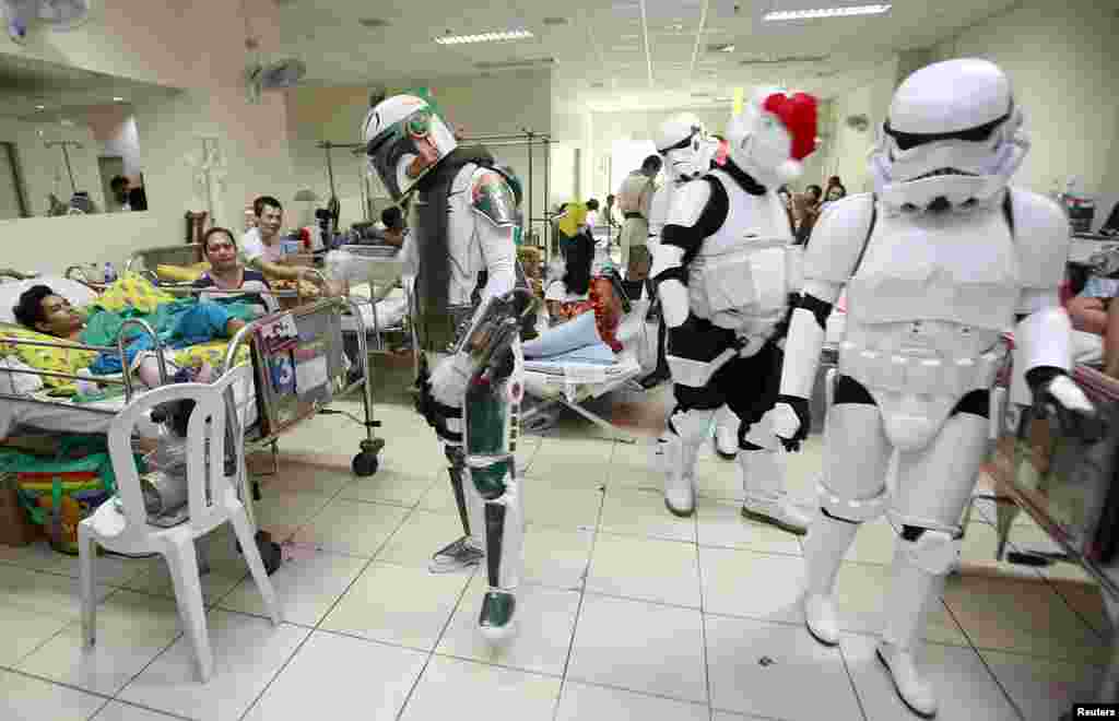 Cosplayers dressed as characters from the Star Wars movie series visit patients during a charity event organized by non-profit group 501st Legion, at East Avenue Medical Center in Quezon city, metro Manila, the Philippines.