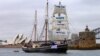 A supplied photo shows a tall ship displaying banners as it sails on Sydney Harbor in Australia, Sept. 8, 2018 as part of global climate change protests across 95 countries organized by the New York-based lobby group 350.org. 
