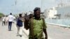 FILE - A Somali soldier patrols near the site of a car bomb outside the UN's office in Mogadishu, Somalia, July 26, 2016.