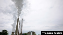 FILE - Exhaust rises from the stacks of the Harrison Power Station in Haywood, W.Va., May 16, 2019.