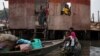 People stand inside a roofless stilt house as the government begins the demolition of illegal homes in Lagos.