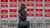 A girl walks by campaign posters for socialist presidential candidate Igor Dodon, in Chisinau, Moldova, Nov. 12, 2016. 