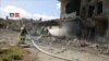 FILE - Firefighters respond at the destroyed building of Nabd Al-Hayat hospital that was hit by an airstrike in Hass, Idlib province, Syria, May 6, 2019, in this still image taken from a video on May 9, 2019. 
