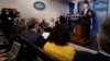 Attorney General Jeff Sessions, right, accompanied by White House press secretary Sean Spicer, second from right, talks to the media during the daily press briefing at the White House in Washington, Monday, March 27, 2017. 