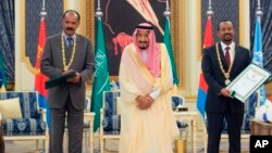 In this photograph released by the state-run Saudi Press Agency, Saudi King Salman, center, receives Eritrean President Isaias Afwerki, left, and Ethiopian Prime Minister Abiy Ahmed, right, in Jiddah, Saudi Arabia on Sept. 16, 2018. 
