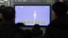 South Koreans watch a television broadcast reporting the country's first rocket launch at Seoul Railway Station in Seoul, South Korea, January 30, 2013.