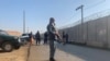 Security stand guard near the site of attack near the Bagram Air Base in Parwan province of Kabul, Afghanistan, Wednesday, Dec. 11, 2019.
