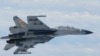 In this undated photo released by Japan Ministry of Defense, a Chinese SU-27 fighter plane is shown. China and Japan are blaming each other for a close encounter between military jets over the East China Sea.