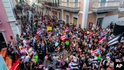 Demonstrators protest against Gov. Ricardo Rossello in San Juan, Puerto Rico, Sunday, July 21, 2019. 