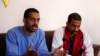 FILE - Alexanda Amon Kotey, left, and el-Shafee Elsheikh, who were allegedly among four British jihadis who made up an Islamic State cell dubbed "The Beatles," speak during an interview with The Associated Press in Kobani, Syria, March 30, 2019.